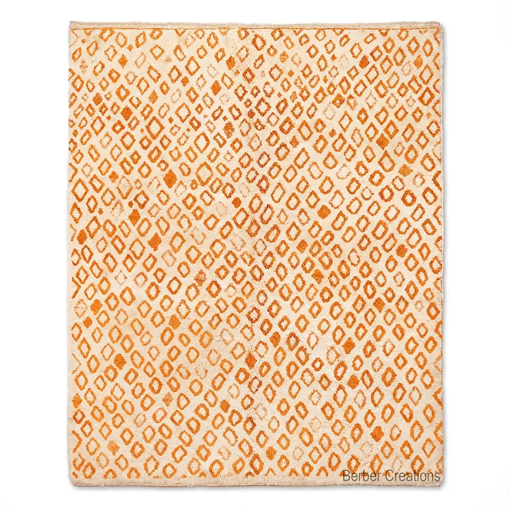 Handcrafted Moroccan Berber rug with a dense, all-over pattern of small orange diamond shapes on a natural beige background. The design is a classic, repetitive geometric motif