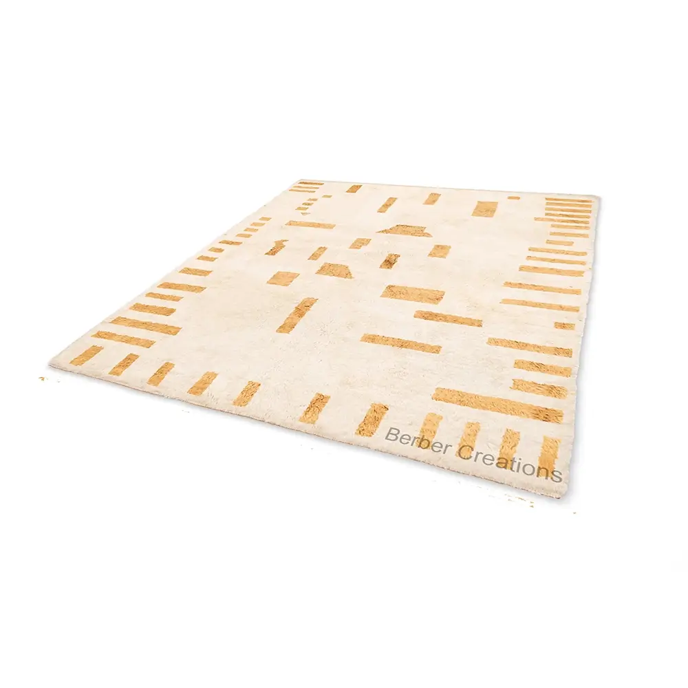 Abstract Moroccan Wool Rug in off-white with gold geometric patterns flat lay