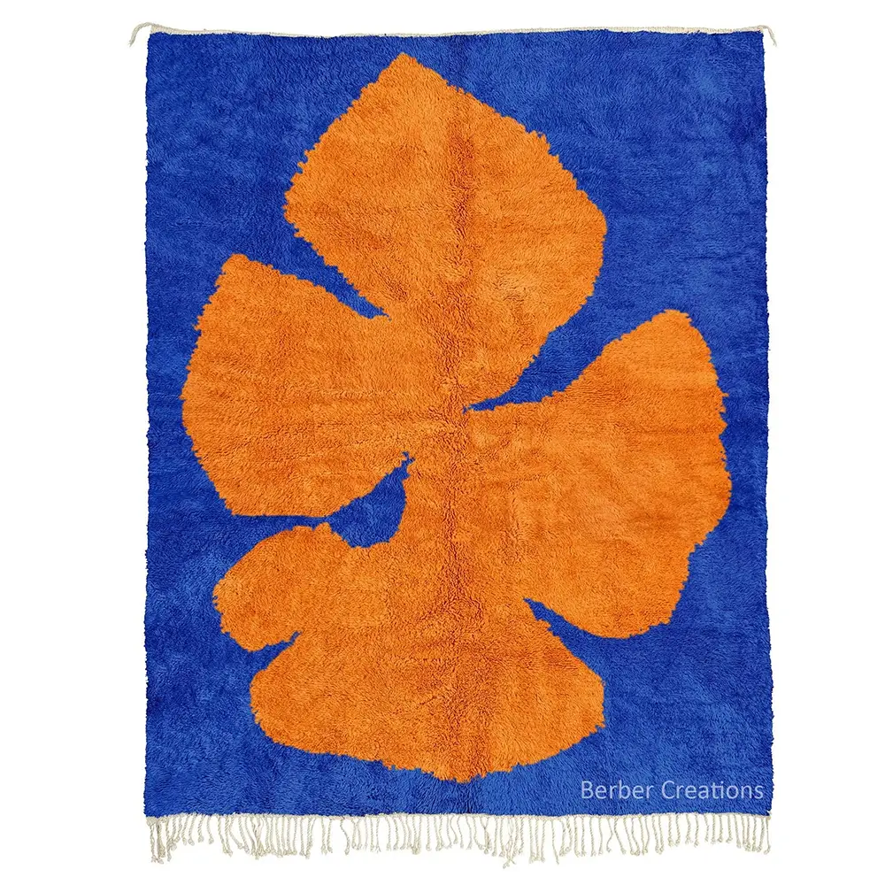 Blue and Orange Abstract Art Rug with a large orange leaf motif on a royal blue