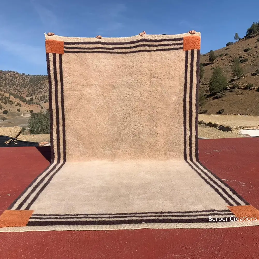 Beni Mrirt minimalist high-pile shag rug in beige with a triple-striped brown border and orange corner accents
