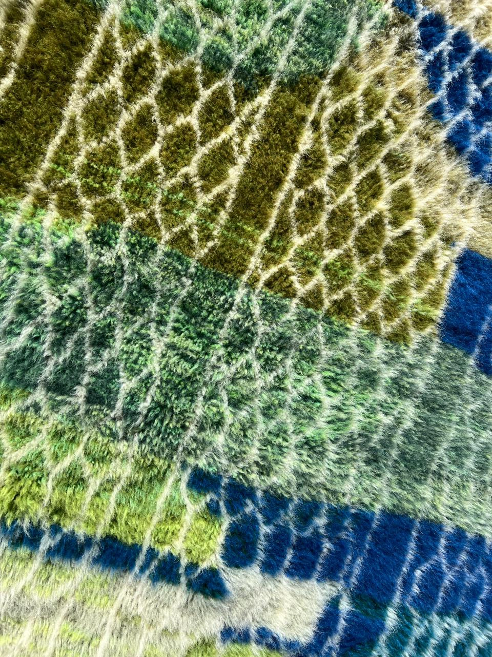 contemporary Moroccan wool rug green, navy blue, and sage details