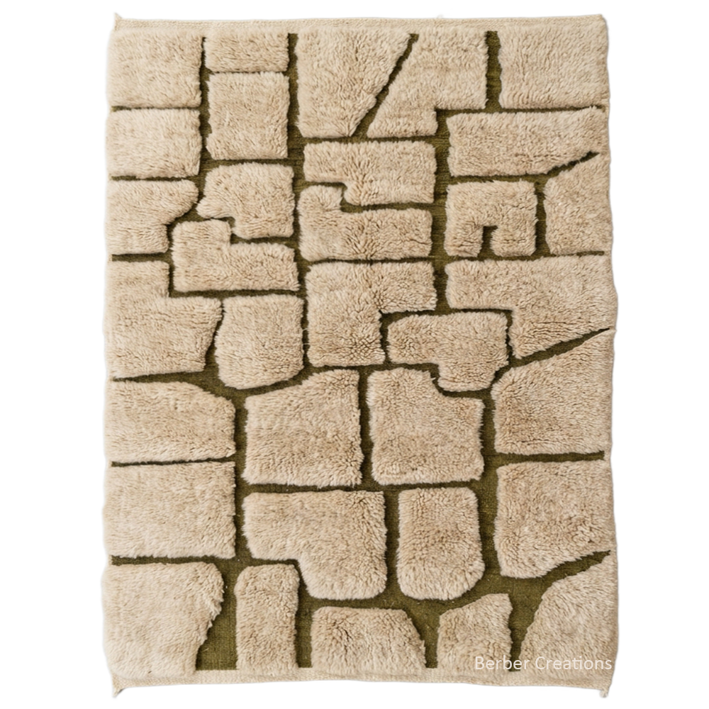 Custom-sized 3D relief Moroccan rug "The Atlas Cobblestone" by Berber Creations. Features raised sand-colored wool blocks on a flat-weave olive green base. High-low sculptural texture in 100% wool, made in our Atlas workshop.