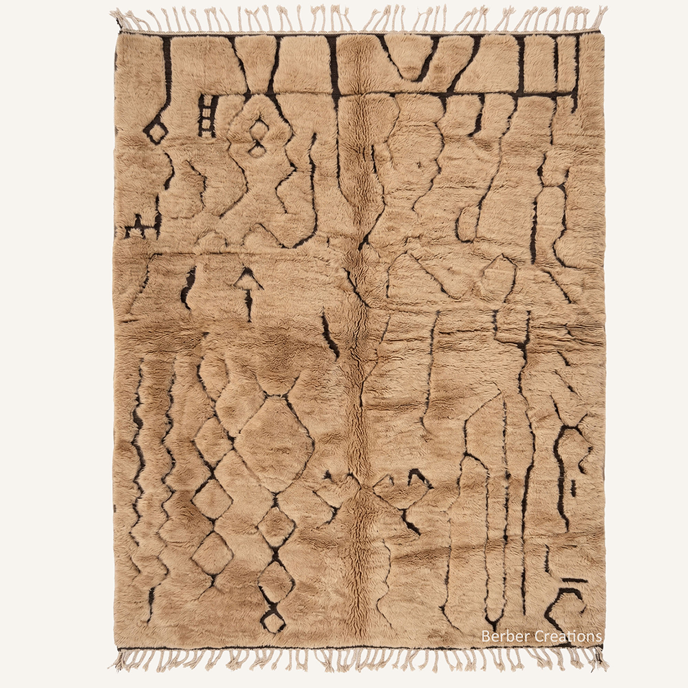 Sienna Silhouette rug featuring a warm honey-tan plush wool with intricate black tribal Berber symbols, handcrafted in the Atlas Mountains workshop.