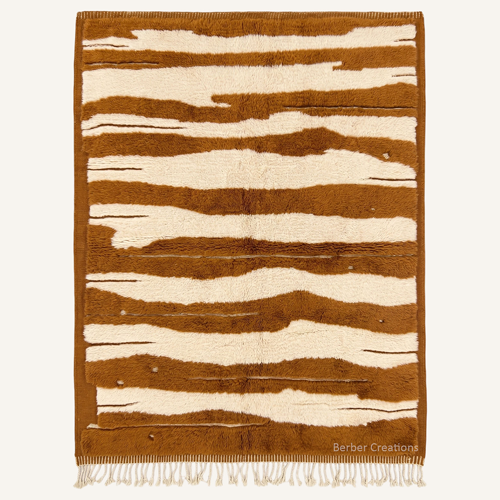 The Cinnamon Dune authentic tawny-cinnamon and ivory Moroccan wool rug, featuring an organic tiger-stripe pattern formed by an ultra-plush high pile and flat-woven cream lines