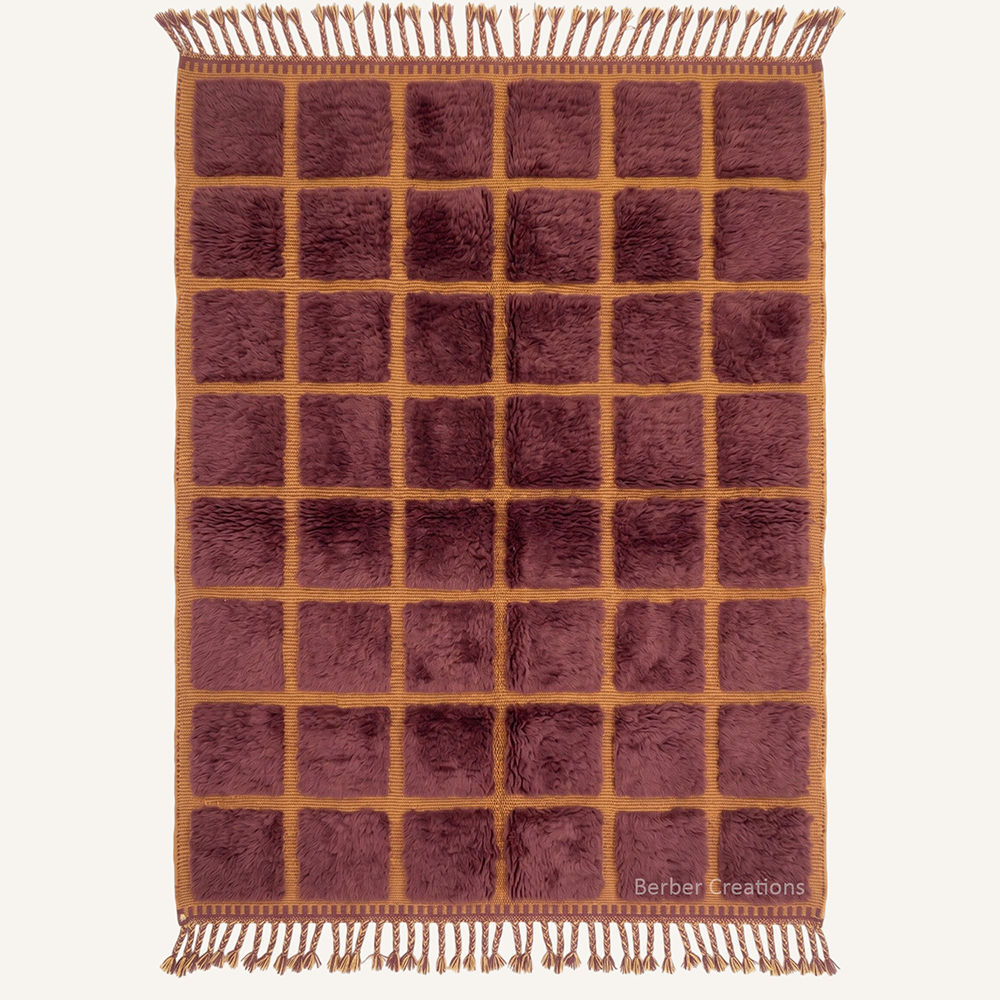The Plum Grid authentic deep-plum and honey-ochre Moroccan wool rug, featuring a structured grid of plush raised squares and intricate hand-braided tassels