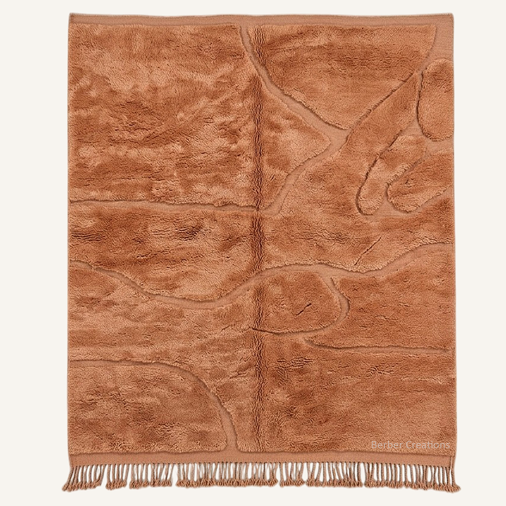 Sculptural "Amber Canyon" Moroccan wool rug with plush monochrome amber pile, featuring organic carved lines, hand-knotted by Berber Creations.