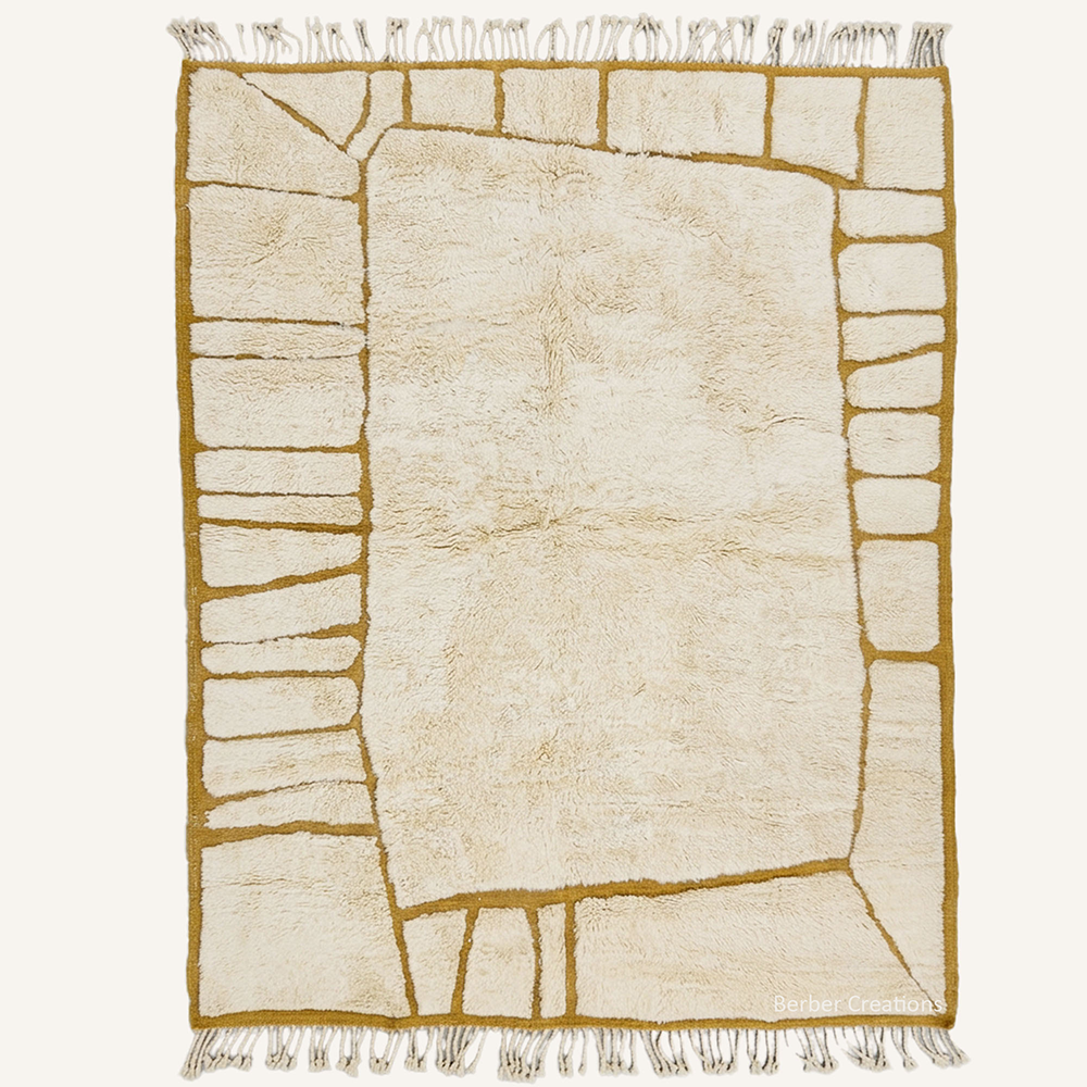 Geometric "Amber Enclave" Moroccan wool rug with plush pile, featuring an open cream center surrounded by a segmented border with rich amber lines, hand-knotted by Berber Creations.