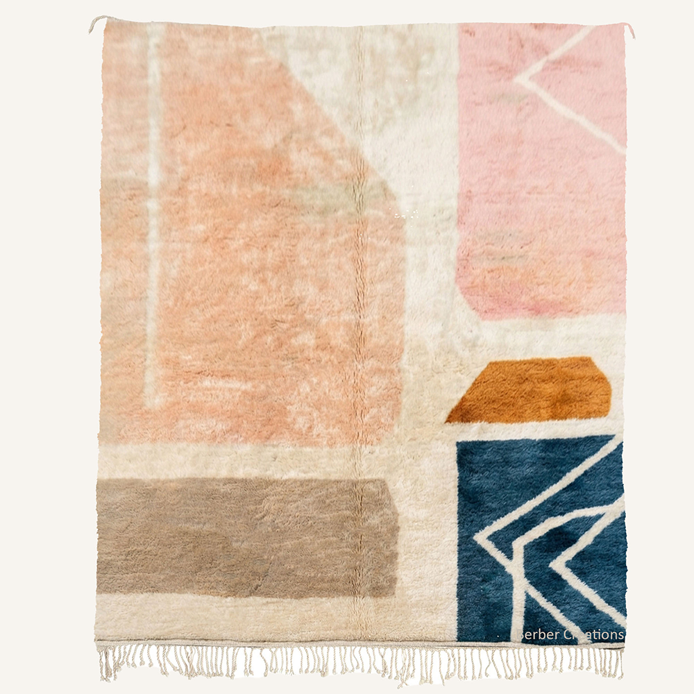 Amina abstract geometric color-block hand-knotted Beni Ourain wool rug featuring Soft Blush sections, a Caramel accent, Taupe base stripes, and a graphic Teal corner block, crafted in the Berber Creations workshop.
