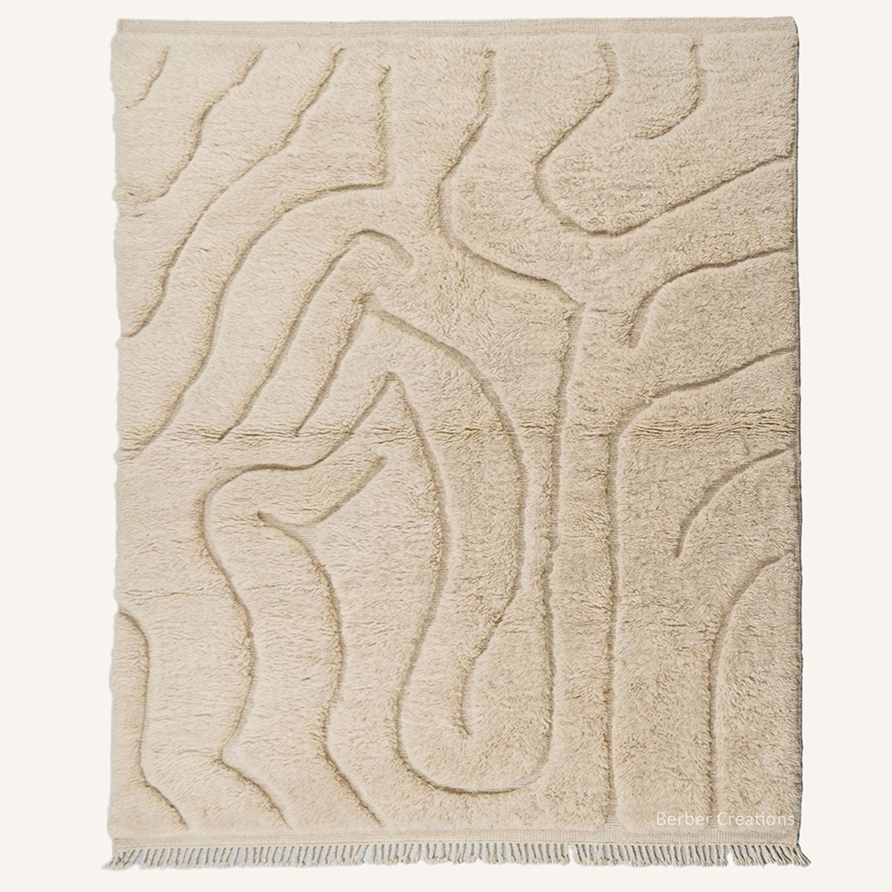 Sculpted monochrome "Cream Dunes" Moroccan wool rug with high-low plush pile, featuring carved organic wave textures on an all-cream background, hand-knotted by Berber Creations.