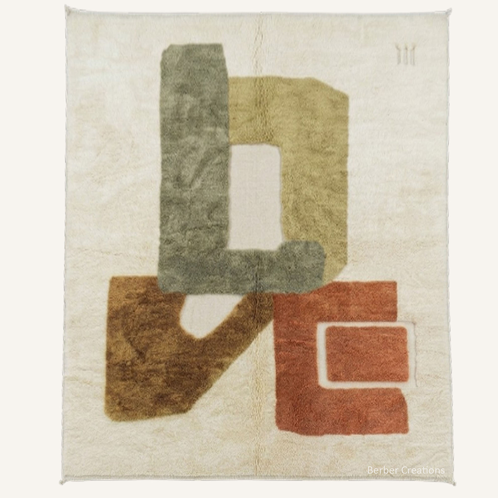 Abstract "Sculpted Amour" Moroccan wool rug with plush pile, featuring geometric blocks forming "LOVE" in sage, amber, and terracotta, hand-knotted by Berber Creations.
