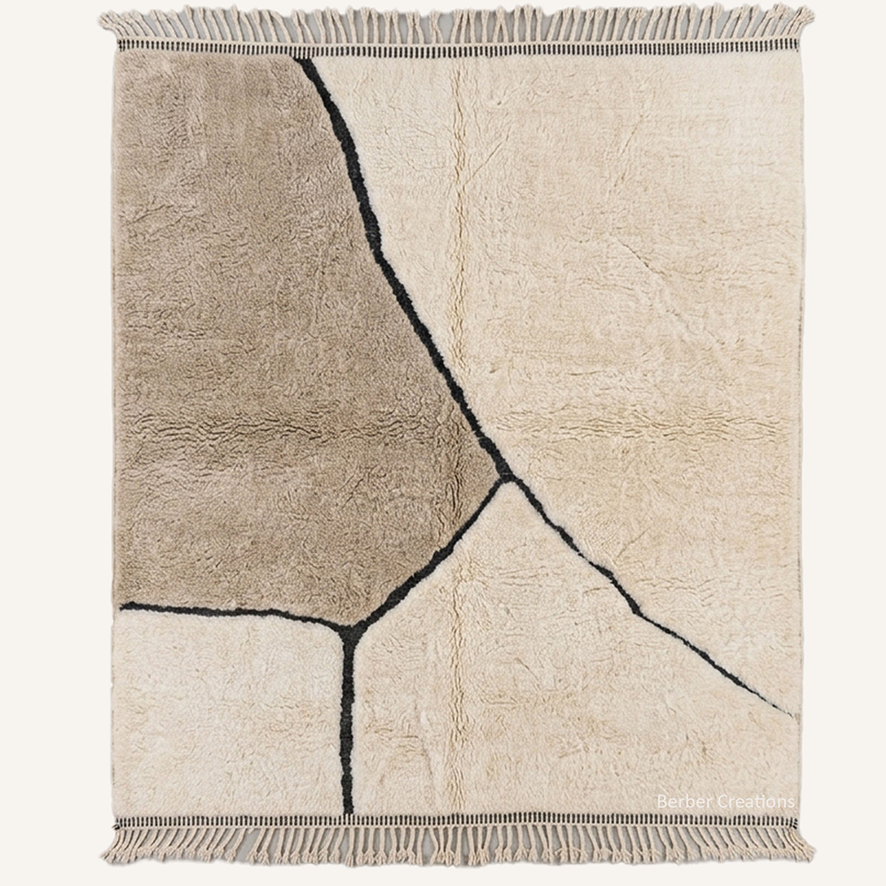 Minimalist geometric "Earth Fractures" Moroccan wool rug with plush pile, featuring a taupe abstract color block and fractured black lines on a cream background, hand-knotted by Berber Creations.