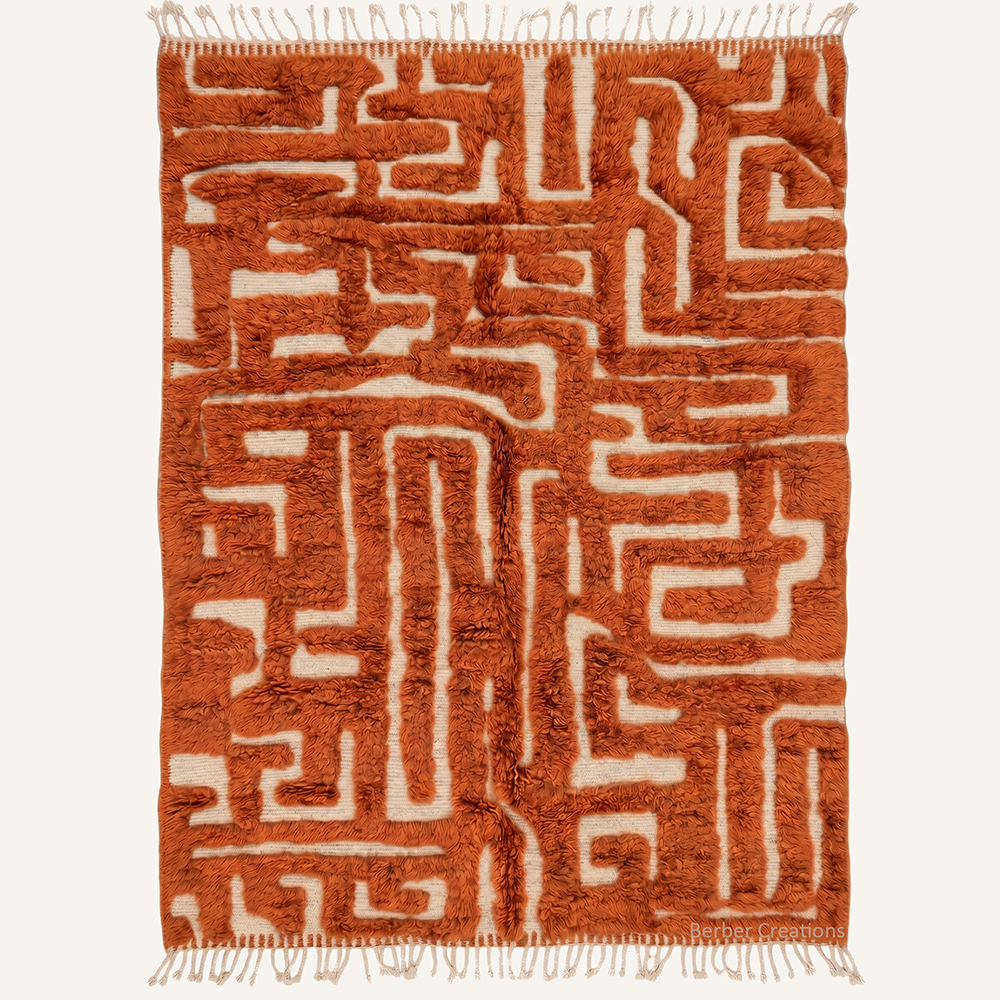 Ines abstract labyrinth maze hand-knotted Beni Mrirt wool rug featuring a carved Rust Orange pattern over a cream base, crafted in the Berber Creations workshop.