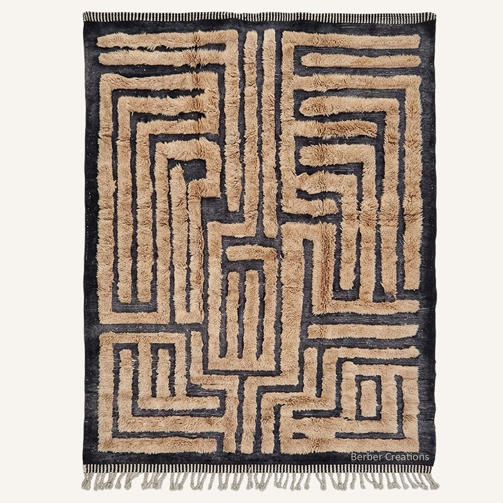 Ines minimalist labyrinth hand-knotted Beni Ourain wool rug featuring a geometric maze pattern in Sand Beige over a dense Charcoal base, crafted in the Berber Creations workshop.