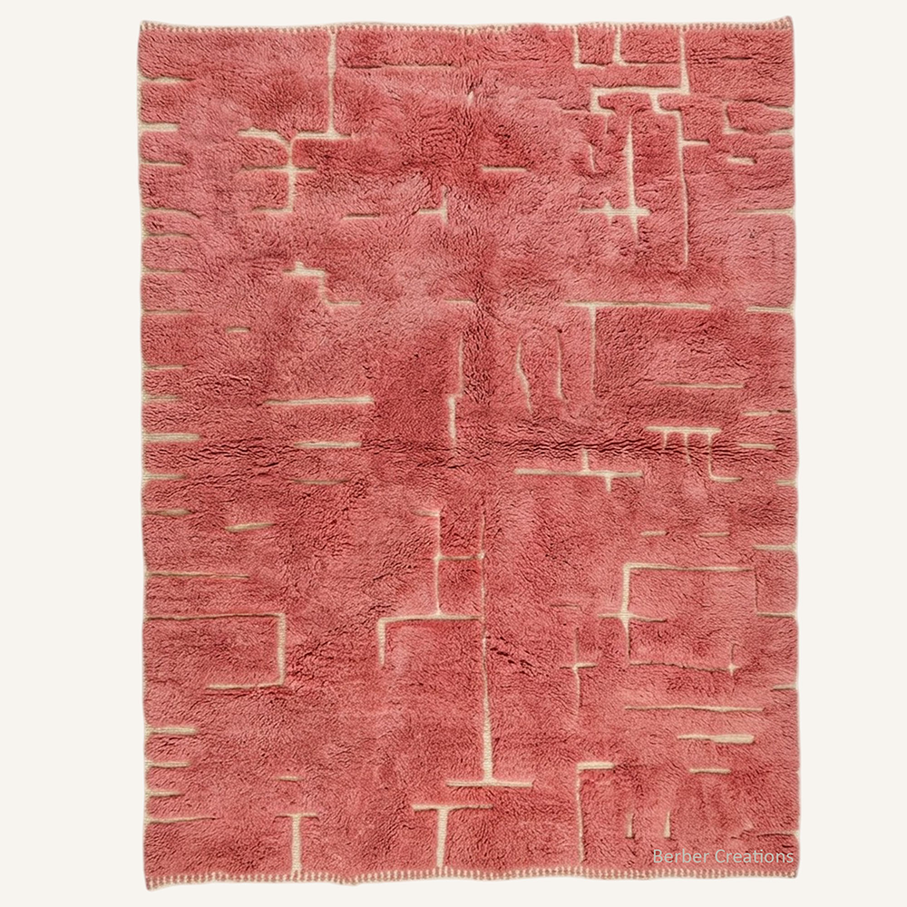 Layal abstract linear carved hand-knotted Beni Mrirt wool rug featuring an intricate geometric pattern in Dusty Rose Pink over a cream base, crafted in the Berber Creations workshop.