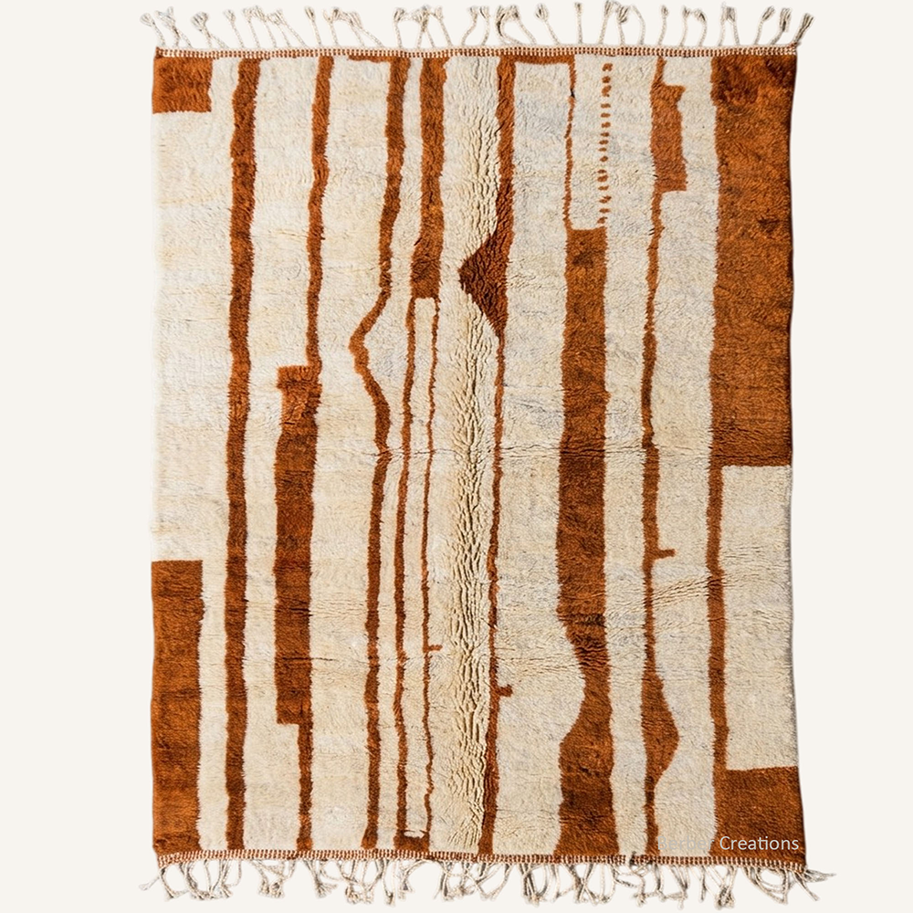 Layali abstract vertical stripe hand-knotted Beni Mrirt wool rug featuring heavy organic bands in Burnt Orange over a plush cream base, crafted in the Berber Creations workshop.