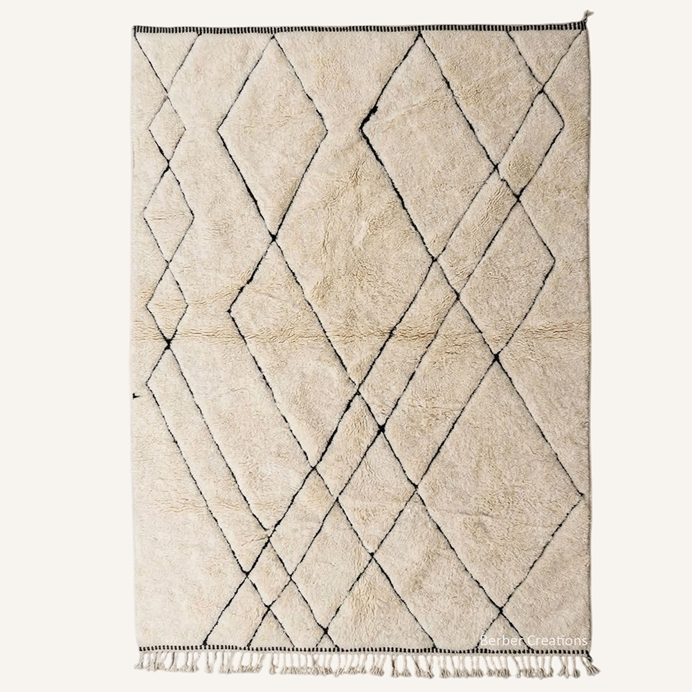 Layla minimalist asymmetric diamond lattice hand-knotted Beni Ourain wool rug featuring fine charcoal lines over a plush cream base, crafted in the Berber Creations workshop.
