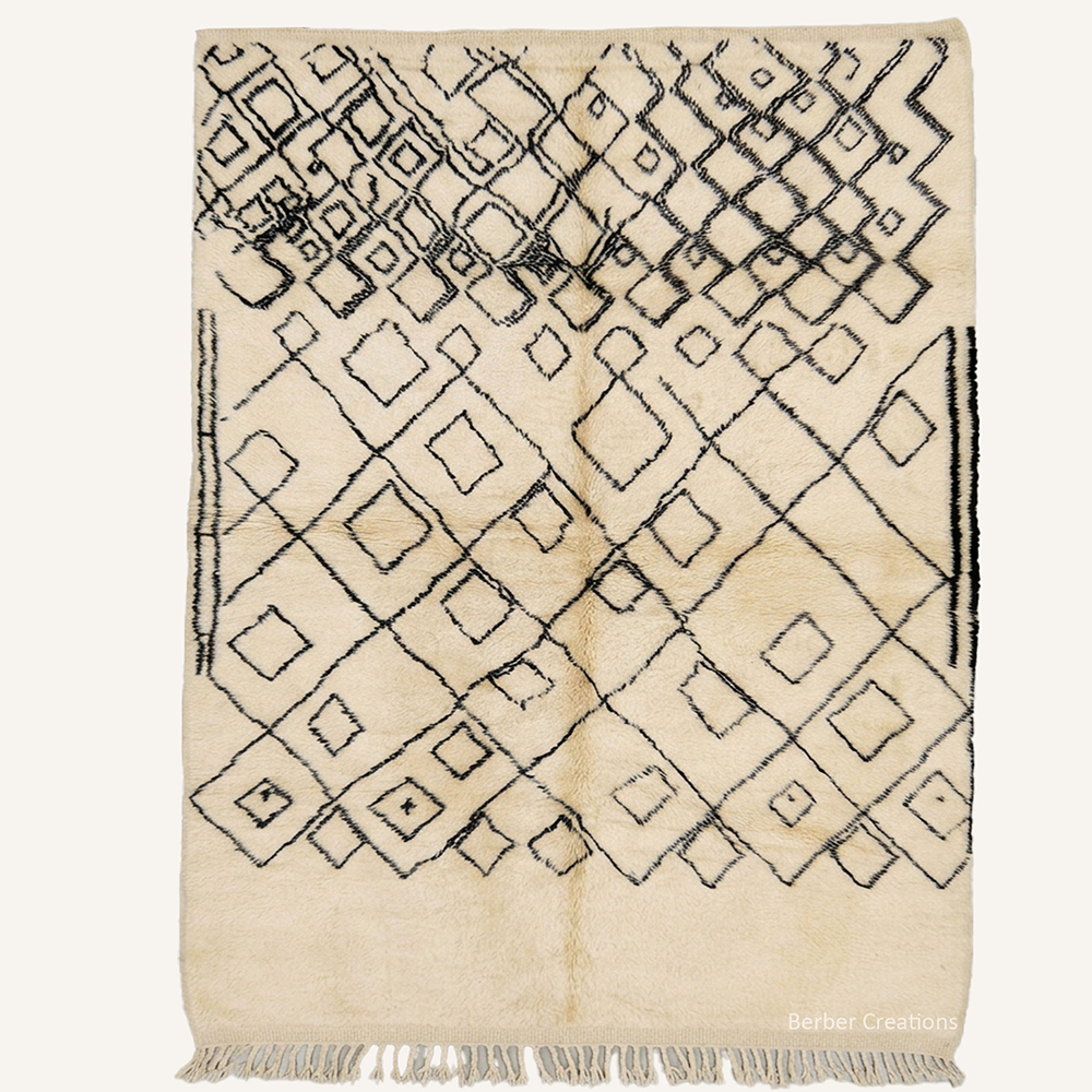 Nadia transitional diamond lattice hand-knotted Beni Ourain wool rug featuring a fading geometric pattern in cream and black, crafted in the Berber Creations workshop.