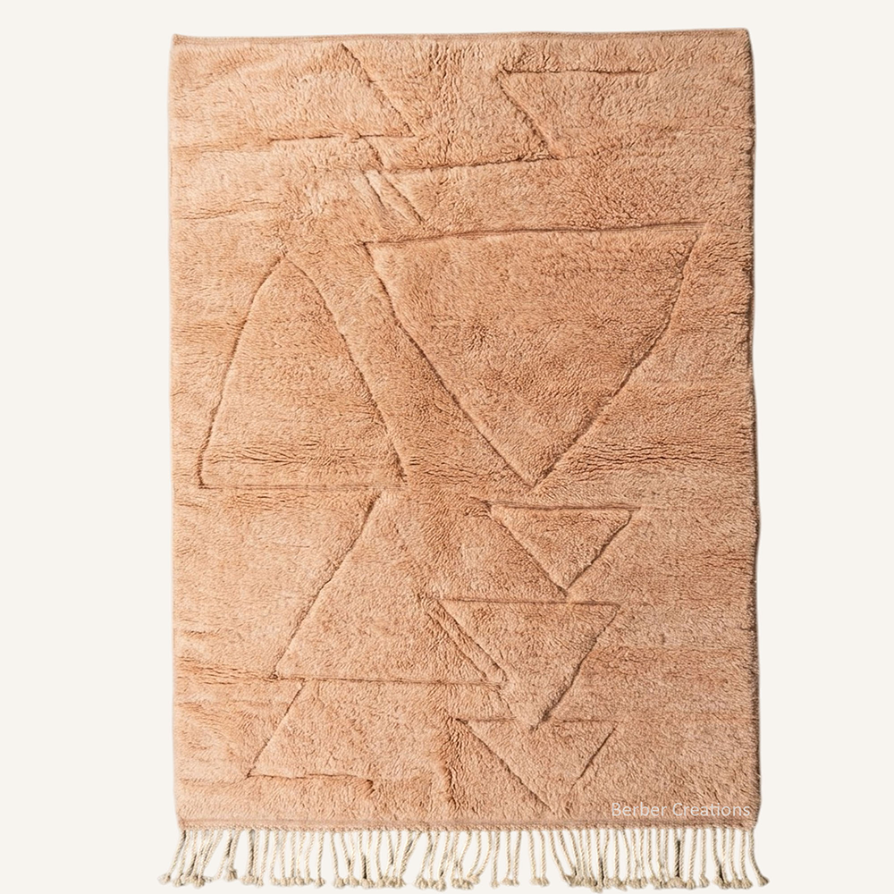 Safia carved geometric hand-knotted Beni Mrirt wool rug in soft Desert Rose with a high-and-low triangle pattern, crafted in the Berber Creations workshop.