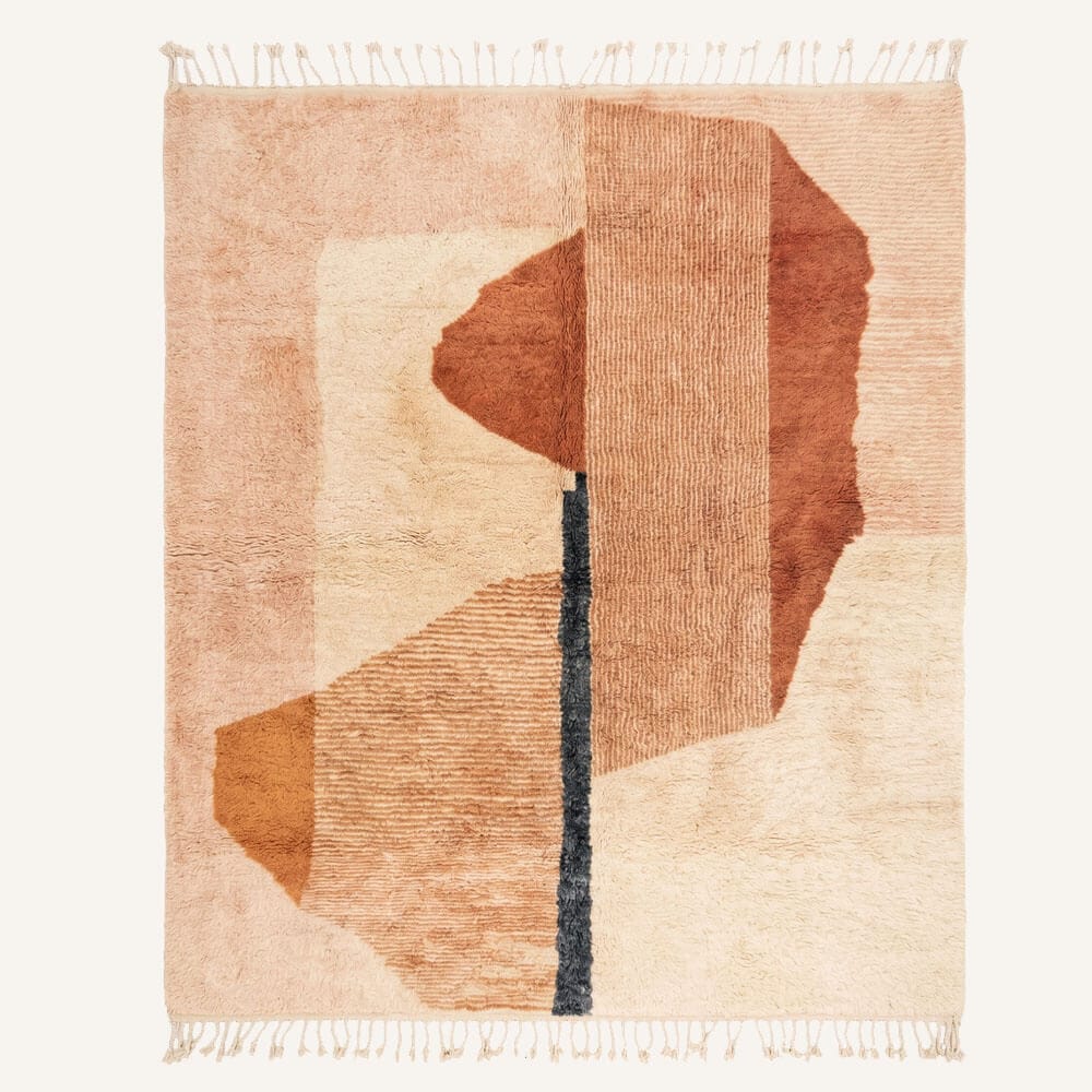 handmade Moroccan Berber wool rug featuring organic abstract geometric shapes in burnt terracotta, dusty rose pink, sand beige, and cream tones anchored by a central charcoal accent stripe and braided fringe.