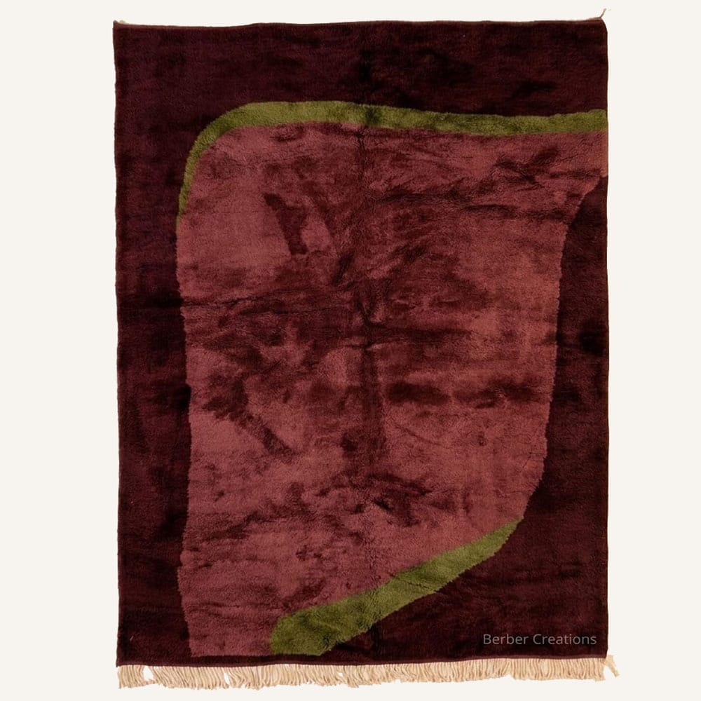 Asklu handmade Moroccan Berber wool rug featuring a deep burgundy background with a dusty rose organic central shape framed in olive green