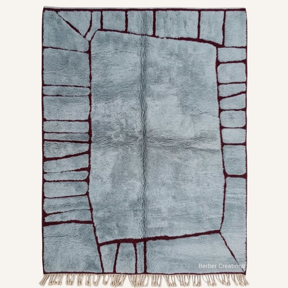 Aza handmade Moroccan Berber wool rug featuring a plush dusty slate blue center enclosed by an organic burgundy panel grid frame