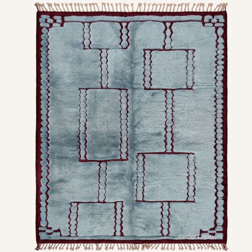 Taziri handmade Moroccan Berber wool rug featuring a plush dusty blue field with interconnected deep burgundy geometric frames, squiggled lines, and a dark border